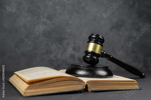 law concept, judge's gavel on top of open books, on dark background