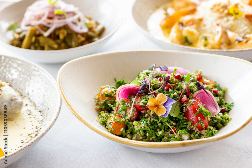 Tabouli quinoa salad topped with edible flowers and red radish. Tabouli quinoa salad topped with edible flowers and red radish.