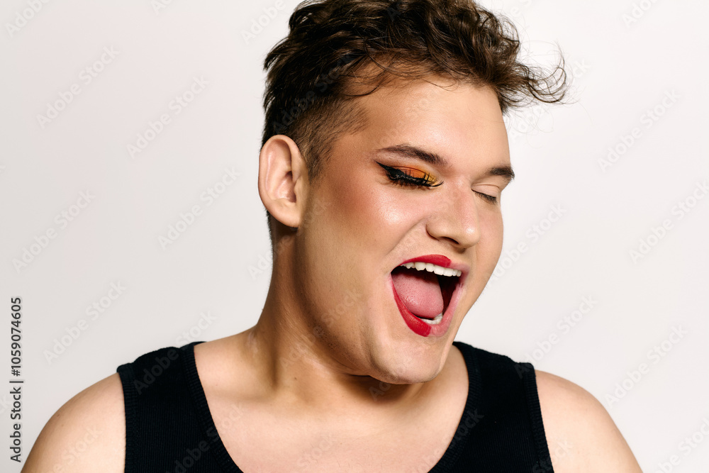 This engaging portrait features a queer individual expressing happiness with creative makeup. This engaging portrait features a queer individual expressing happiness with creative makeup.