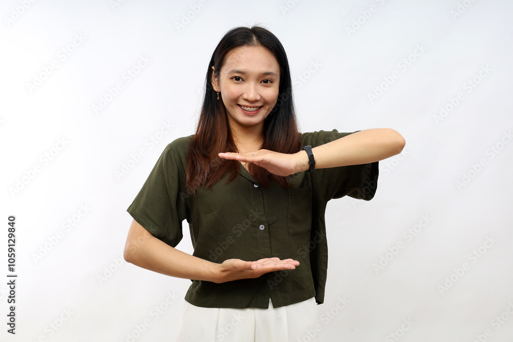 Young woman wearing casual green shirt gesturing with hands showing big and large size sign, measure symbol. smiling looking at the camera. measuring concept. Young woman wearing casual green shirt gesturing with hands showing big and large size sign, measure symbol. smiling looking at the camera. measuring concept.