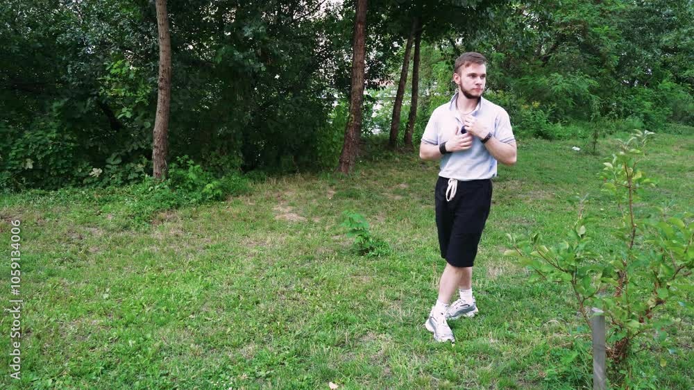 Man walking through a serene park setting, surrounded by greenery. Great for lifestyle and nature-focused videos. Man walking through a serene park setting, surrounded by greenery. Great for lifestyle and nature-focused videos.