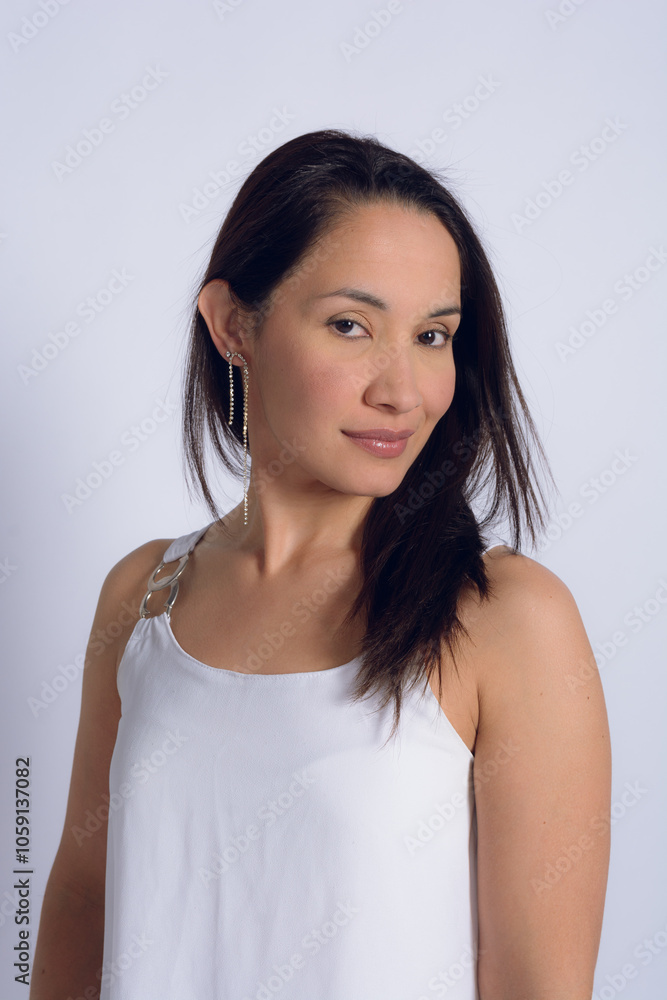 Portrait of a pretty Venezuelan woman in a white dress, studio photo with a white background Portrait of a pretty Venezuelan woman in a white dress, studio photo with a white background
