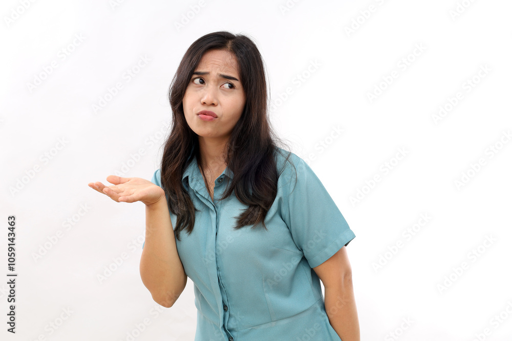 Indignant displeased Asian woman concentrated away has sad expression raises hand with clueless look wears casual shirt earrings poses against white background copy space for text or promotion Indignant displeased Asian woman concentrated away has sad expression raises hand with clueless look wears casual shirt earrings poses against white background copy space for text or promotion