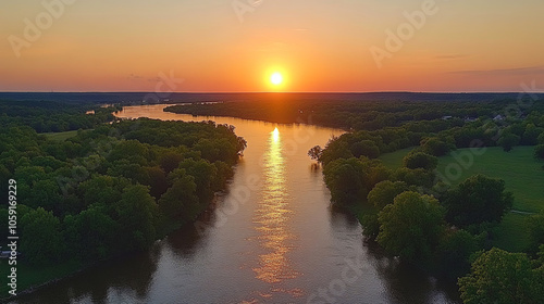 A Vibrant Sunset Reflecting on a Calm River Surrounded by Lush Trees in a Serene Natural Landscape at Dusk