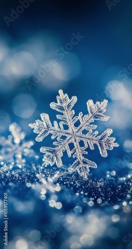 Delicate snowflake resting on glistening winter surface with blurred blue bac...