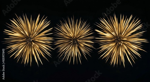 Three golden starburst decorations against a black background for elegant hom...