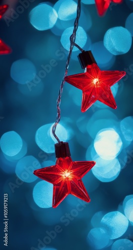 Bright red star ornament glows against a blue and bokeh background during fes...