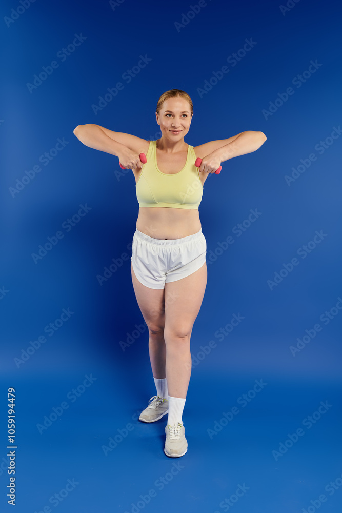 Fototapeta premium A pretty woman exercises diligently in a studio setting, showcasing her dedication to fitness and wellness.