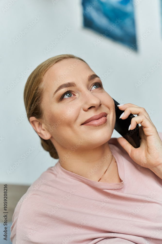 A joyful plus size woman smiles while chatting on the phone in her inviting living space. A joyful plus size woman smiles while chatting on the phone in her inviting living space.