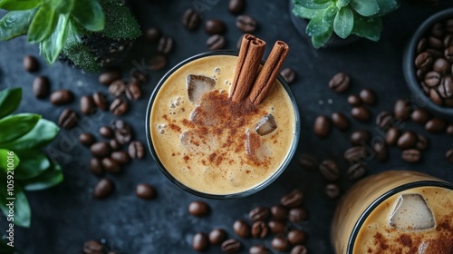 Iced coffee with spices and mint leaves on a dark background with coffee beans