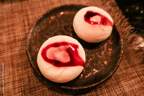 close up of Japanese grilled roasted cheese in round shape with black sugar sauce photo