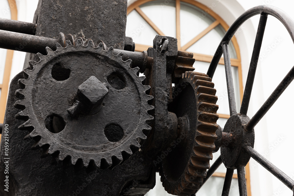Massive old black gears, close-up photo with selective focus Massive old black gears, close-up photo with selective focus
