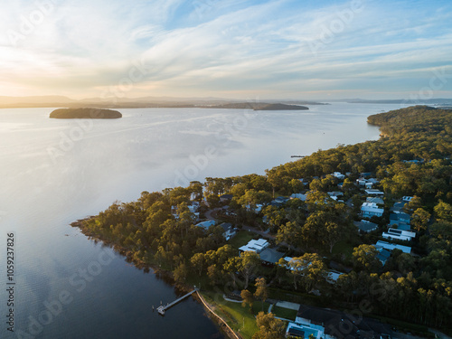 Sunset landscape of houses and trees at Murrays Beach beside Lake Macquarie