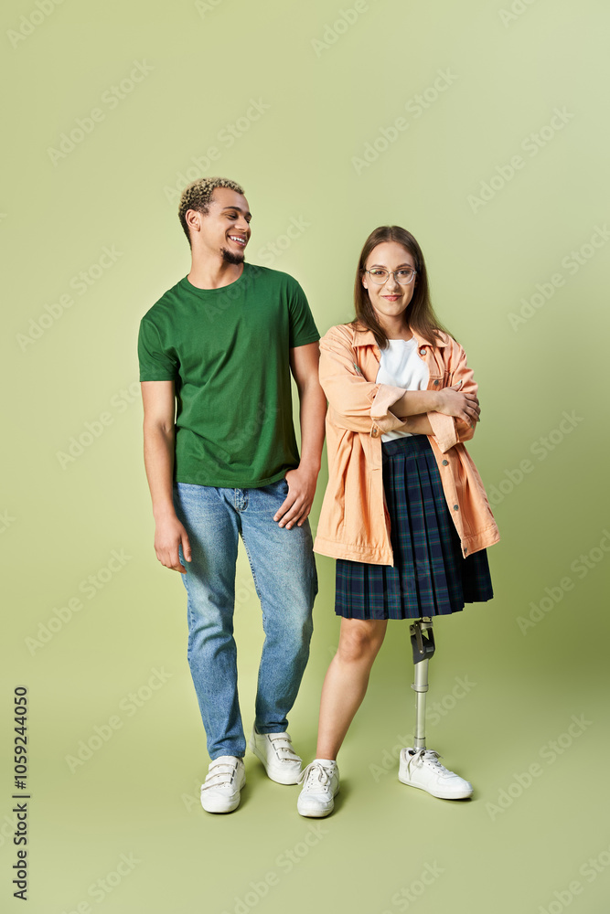 A non binary person smiles next to their friend with a prosthetic leg. A non binary person smiles next to their friend with a prosthetic leg.