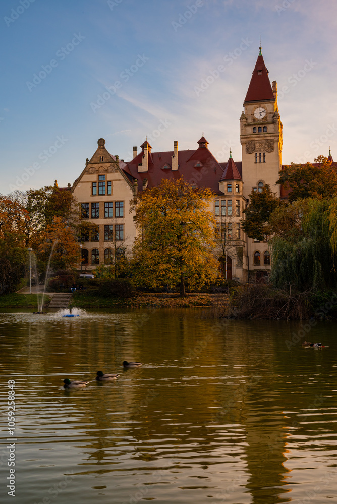 Old university with chapel by the lake in autumn Old university with chapel by the lake in autumn