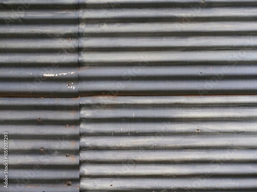 Old corrugated sheet metal wall made of several pieces