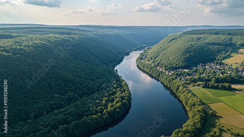 aerial view of serpentine river winding through lush green forest