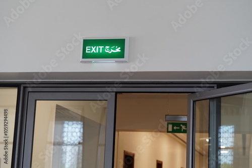  Emergency exit sign. Man running out fire exit