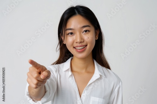 Asian woman manager smiling pointing recruiting over white background.