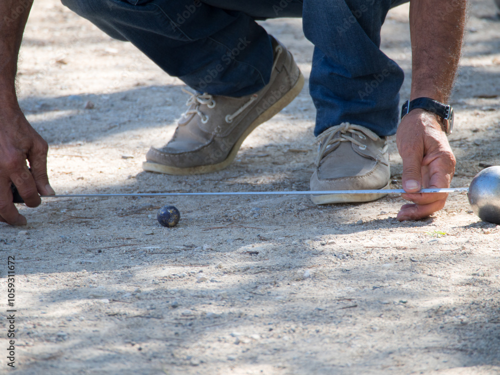 Measuring the distance at a Petanque game, France Measuring the distance at a Petanque game, France