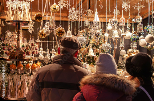 Christmas time, authentic family at market in Vienna, Austria. Traditional Viennese culture. Selective focus on colorful scene.