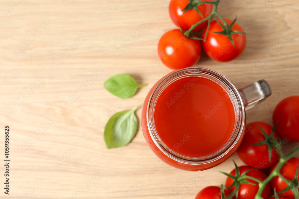 Tomato juice in a glass and fresh tomatoes on the table Tomato juice in a glass and fresh tomatoes on the table