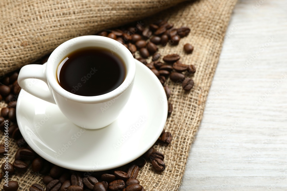Cup of coffee and coffee beans on wooden background Cup of coffee and coffee beans on wooden background