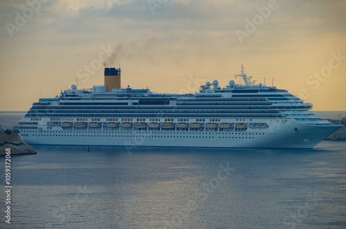 Modern Italian family cruiseship cruise ship liner Fascinosa morning arrival into port of Valletta, Malta with old town skyline and harbor entrance