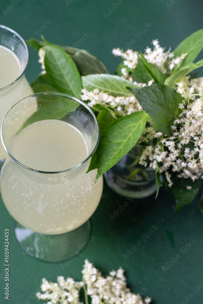 Carbonated elderflower drink. Flower summer kvass in glasses. Sparkling homemade hugo water. Buza