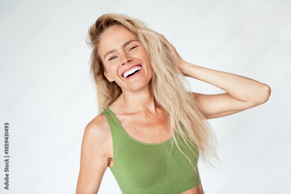 Photo of gorgeous mature blonde lady laugh smile touch hair wear khaki lingerie isolated white background no retouch Photo of gorgeous mature blonde lady laugh smile touch hair wear khaki lingerie isolated white background no retouch