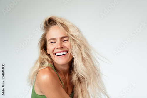 Photo of gorgeous mature blonde lady laugh look empty space wear khaki lingerie isolated white background no retouch