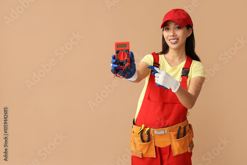Young female electrician po...