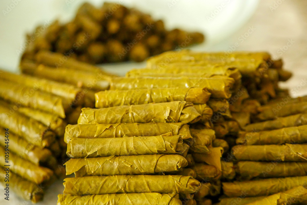 Homemade stuffed vine leaves are arranged in a row on the table,Homemade stuffed vine leaves are arranged in a row on the table,