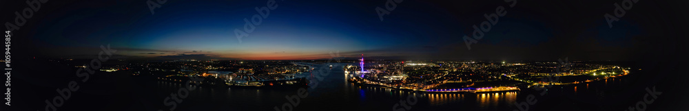 High Angle Night Panoramic View of Illuminated Portsmouth Central City Docks on Ocean Edge at Just After Sunset Time England United Kingdom. Drone Camera Footage Captured on Night of May 15th, 2024 High Angle Night Panoramic View of Illuminated Portsmouth Central City Docks on Ocean Edge at Just After Sunset Time England United Kingdom. Drone Camera Footage Captured on Night of May 15th, 2024