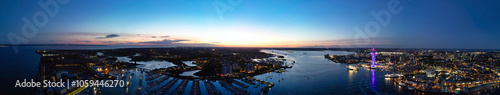 High Angle Night Panoramic View of Illuminated Portsmouth Central City Docks on Ocean Edge at Just After Sunset Time England United Kingdom. Drone Camera Footage Captured on Night of May 15th, 2024