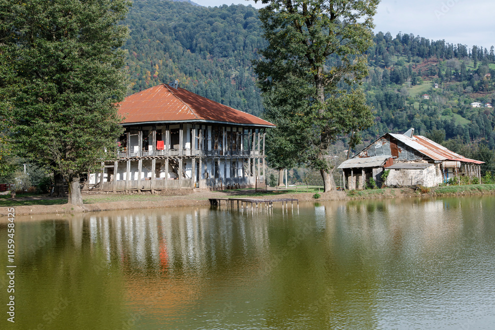 village house near the lake with mirror reflection in water village house near the lake with mirror reflection in water