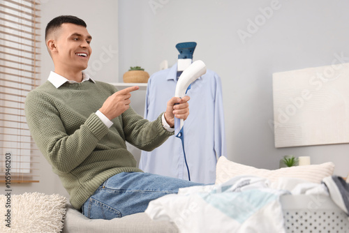 Happy young man with laundr...