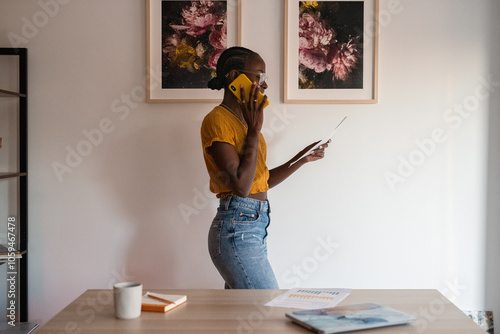 Woman with document using cellphone at home photo