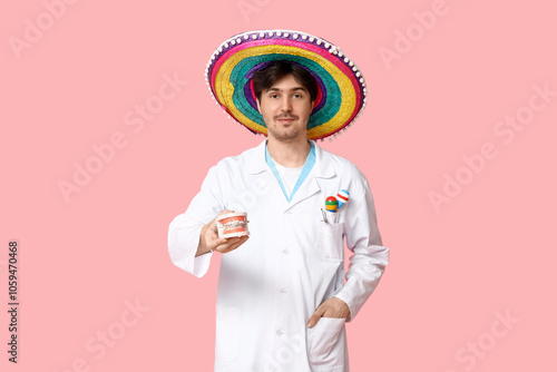 Young male dentist with som...