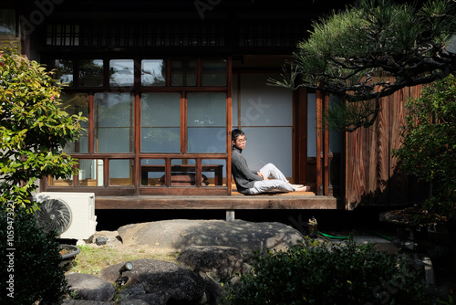 Asian man sitting alone in Japanese lobby's house photo