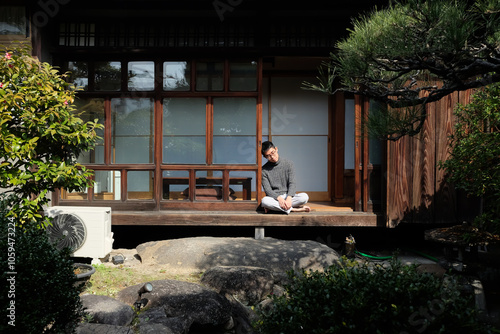 Young man relaxing at the porch of Japanese house photo