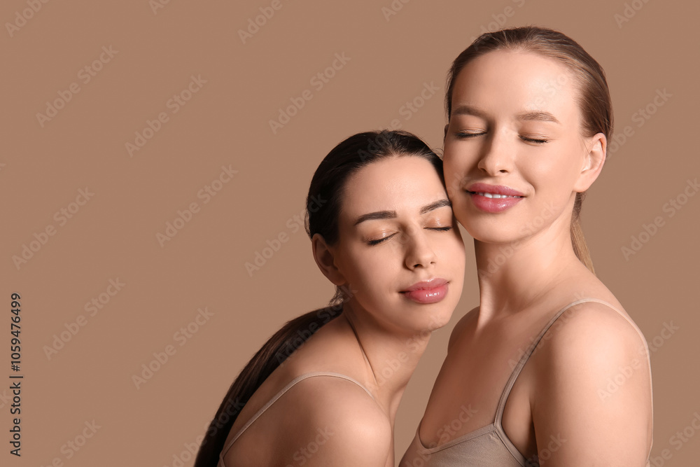 Beautiful young sisters on brown background Beautiful young sisters on brown background