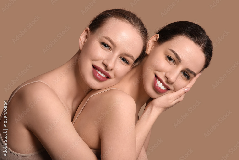 Smiling young sisters on brown background Smiling young sisters on brown background