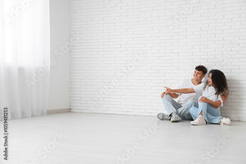 Young happy couple sitting ...