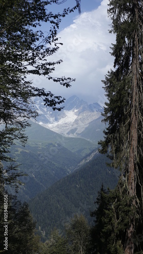 Majestic Mountain Peak With Snow and Clouds in Background