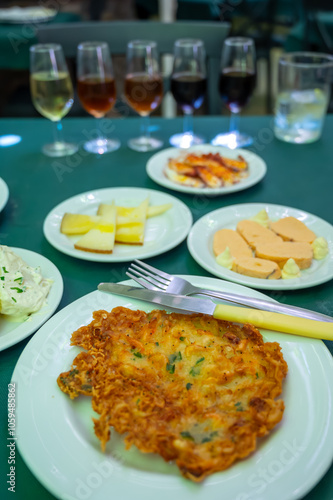 Traditional Andalusian dish from potato and seafood, Tortillitas de Camarones, Shrimp Fritters served with sherry wine in old tavern as tapas, Sanlucar de Barrameda, Spain