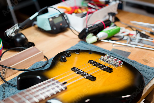 Bass guitar at luthier workshop table photo