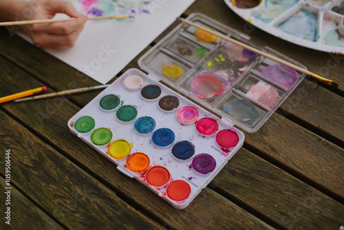 A woman painting with watercolor photo