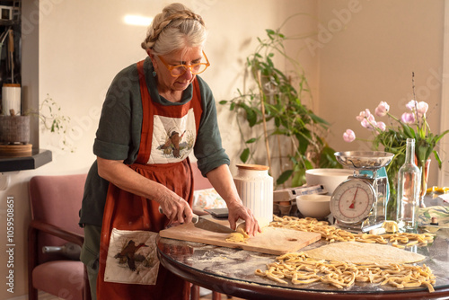 Senior woman candid portrait cooking at home photo