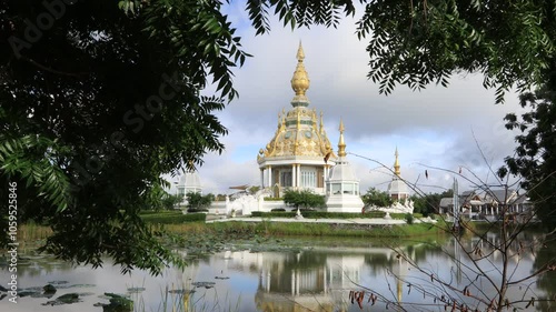 video background of the morning sun light overlooking the old pagoda in the middle of the water(Wat Thung Setthi) in Khon Kaen of Thailand, is beautiful and the blur of the wind blows. photo